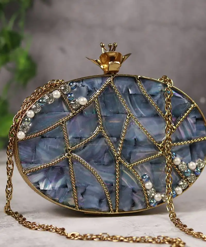 Mother of pearl gold embellished clutch