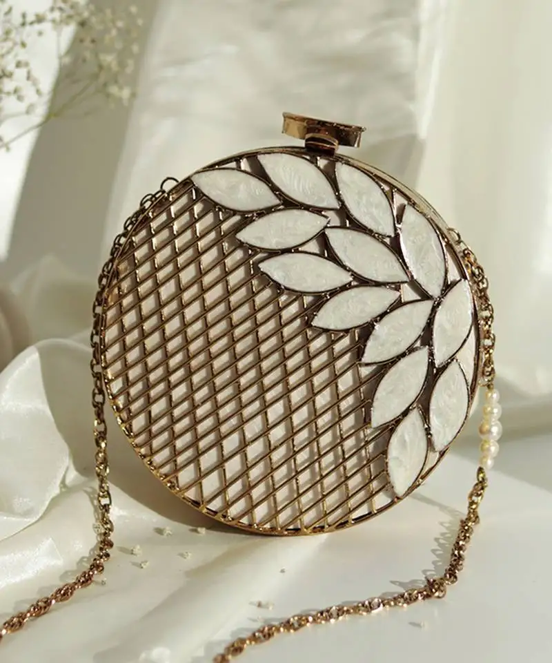 Gold pearl clutch with intricate brass work