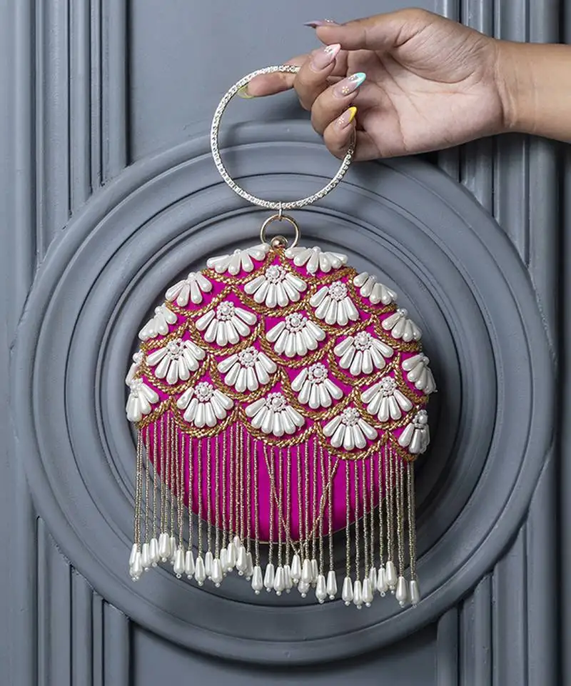 Pink silk hand embroidered clutch with tassles
