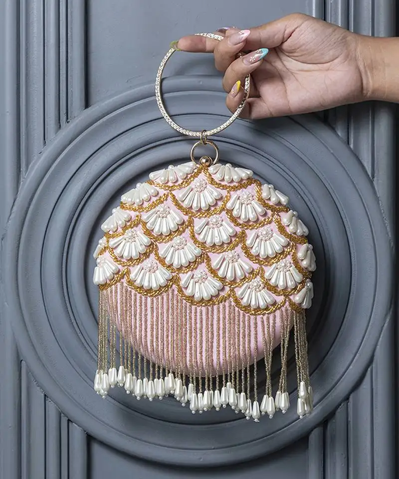 Pink hand embroidered silk clutch with tassles