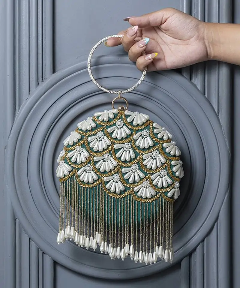 Green hand embroidered silk clutch with tassles