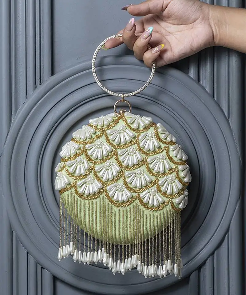 Green silk hand embroidered clutch with tassles