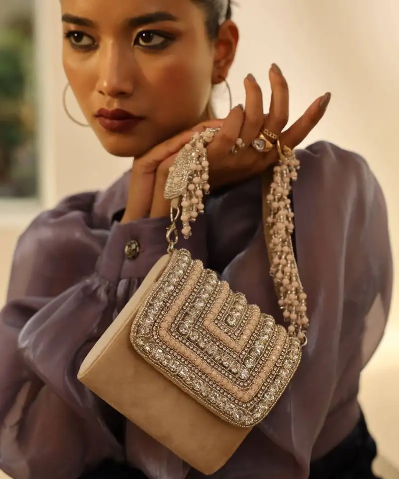 Beige suede mini bag with embroidered handle