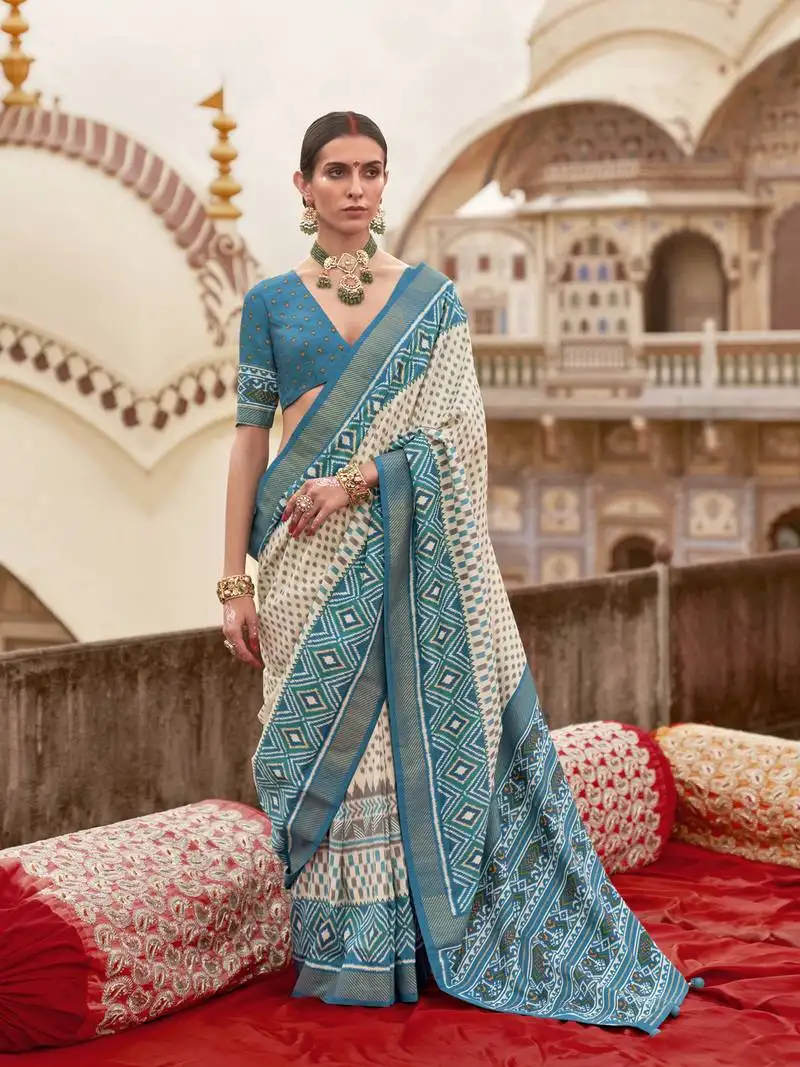 Off white poly viscose silk ikkat printed patola saree with sea blue weaving border
