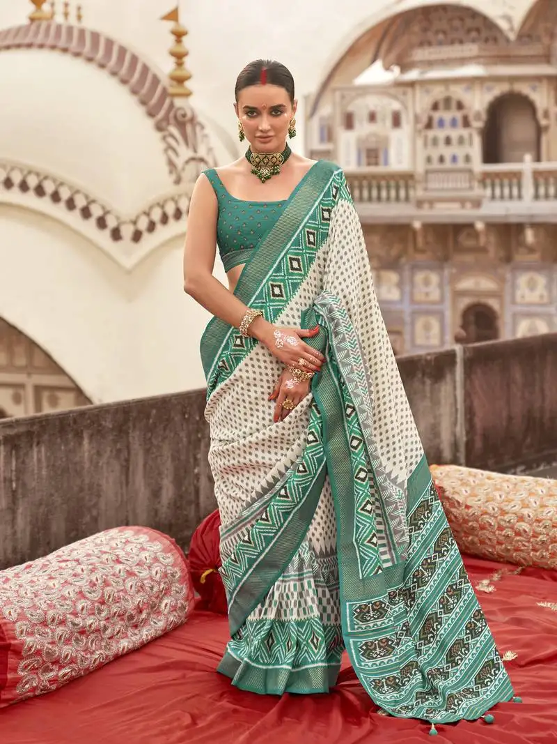 Off white poly viscose silk ikkat printed patola saree with teal weaving border