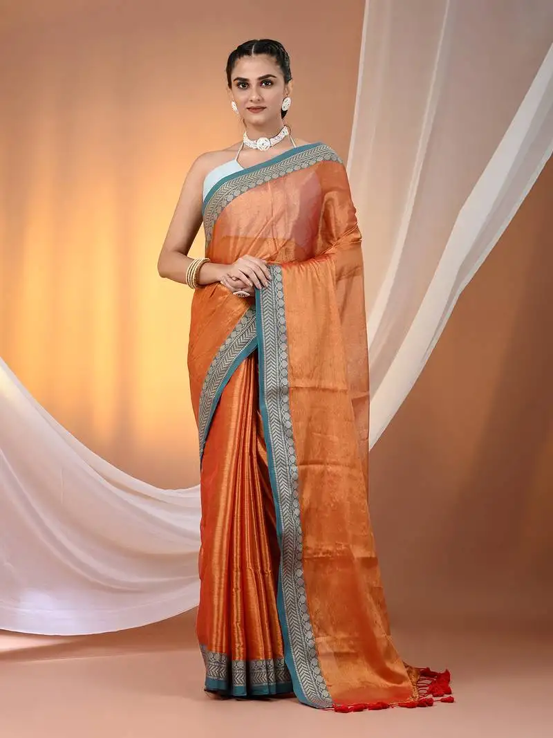 Orange shimmer tissue saree with nakshi borders