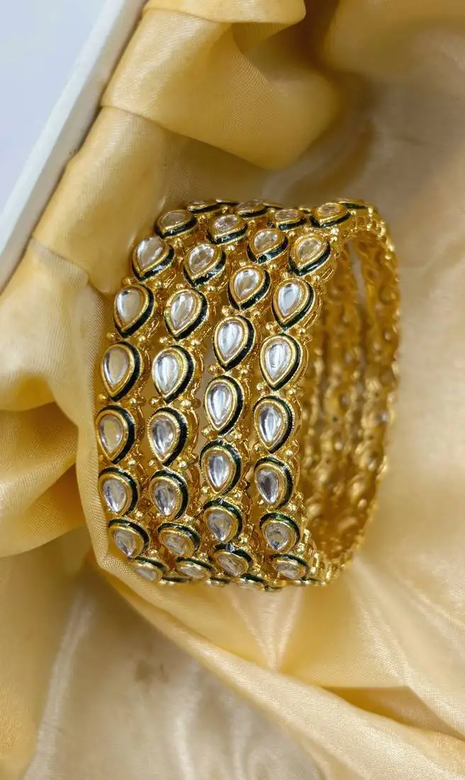 Gold designer bangle set with green touch for women