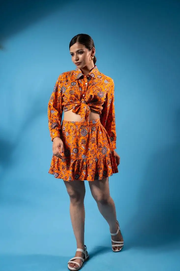 Orange floral crop top and ruffled skirt set