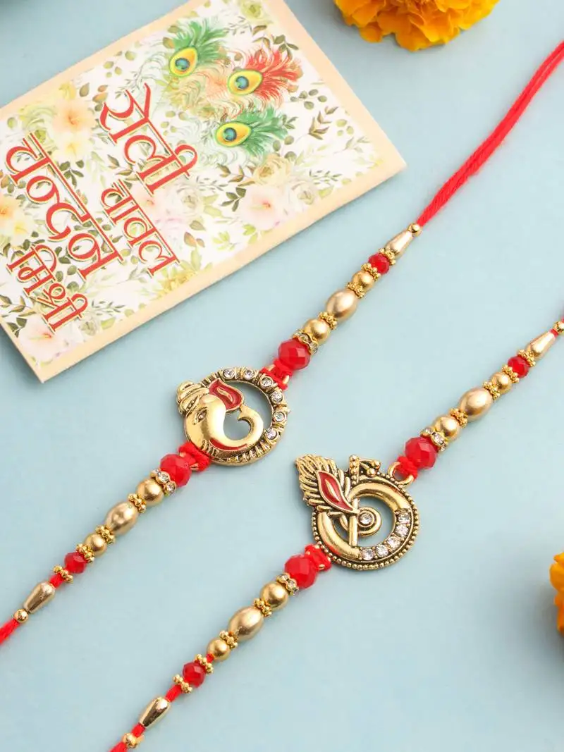 set of 2 golden red religious designer ganesh ji thread rakhi with roli chawal chandan & mishri