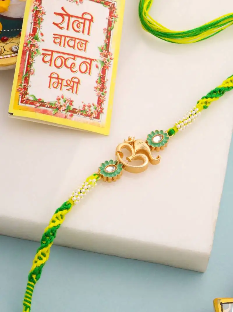 Men green kundan studded om design thread rakhi with roli chawal chandan & mishri
