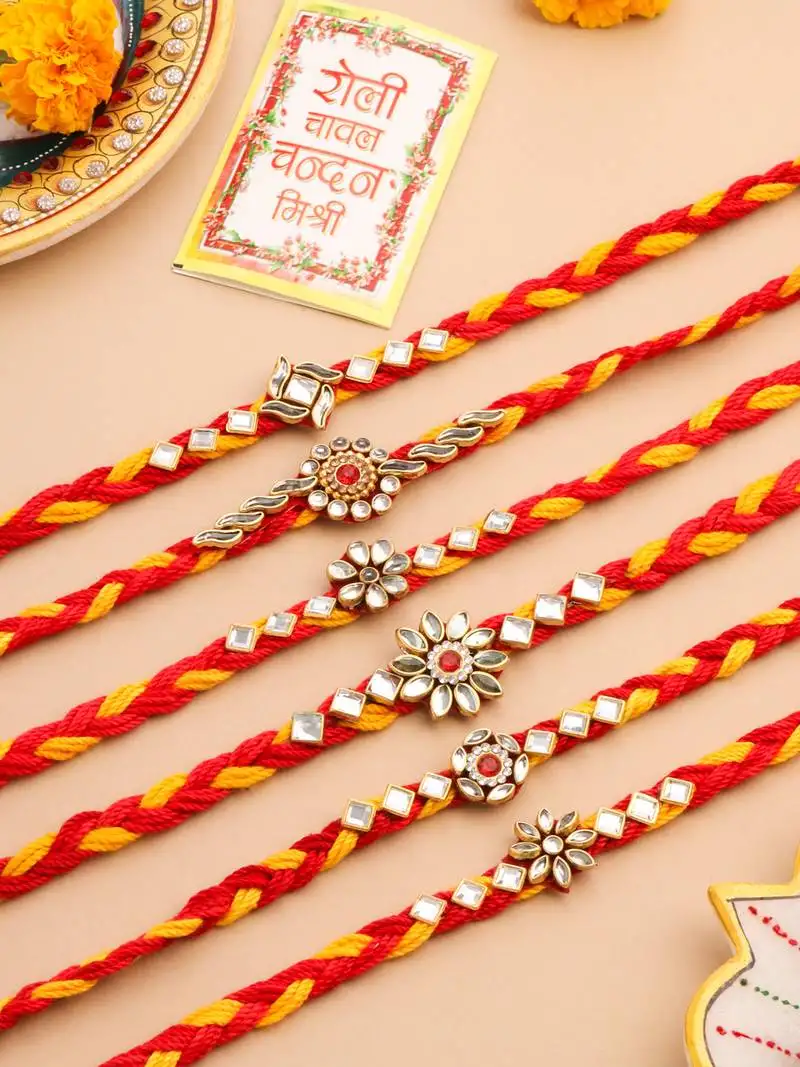 set of 6 red & yellow kundan studded floral design thread rakhi with roli chawal chandan & mishri