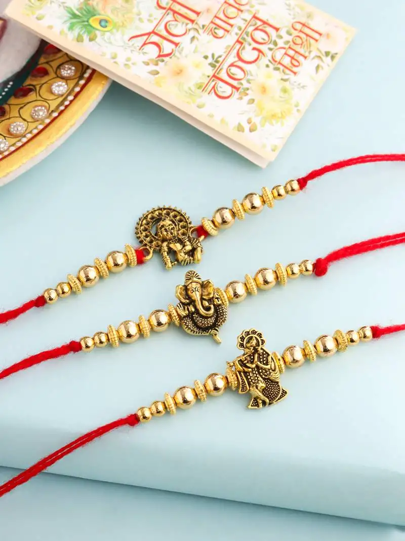 set of 3 gold toned designer ganesh ji thread rakhi with roli chawal chandan & mishri