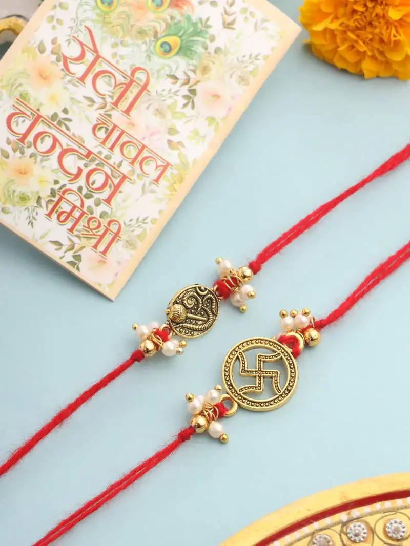 set of 2 gold toned pearls swastik desgin thread rakhi with roli chawal chandan & mishri