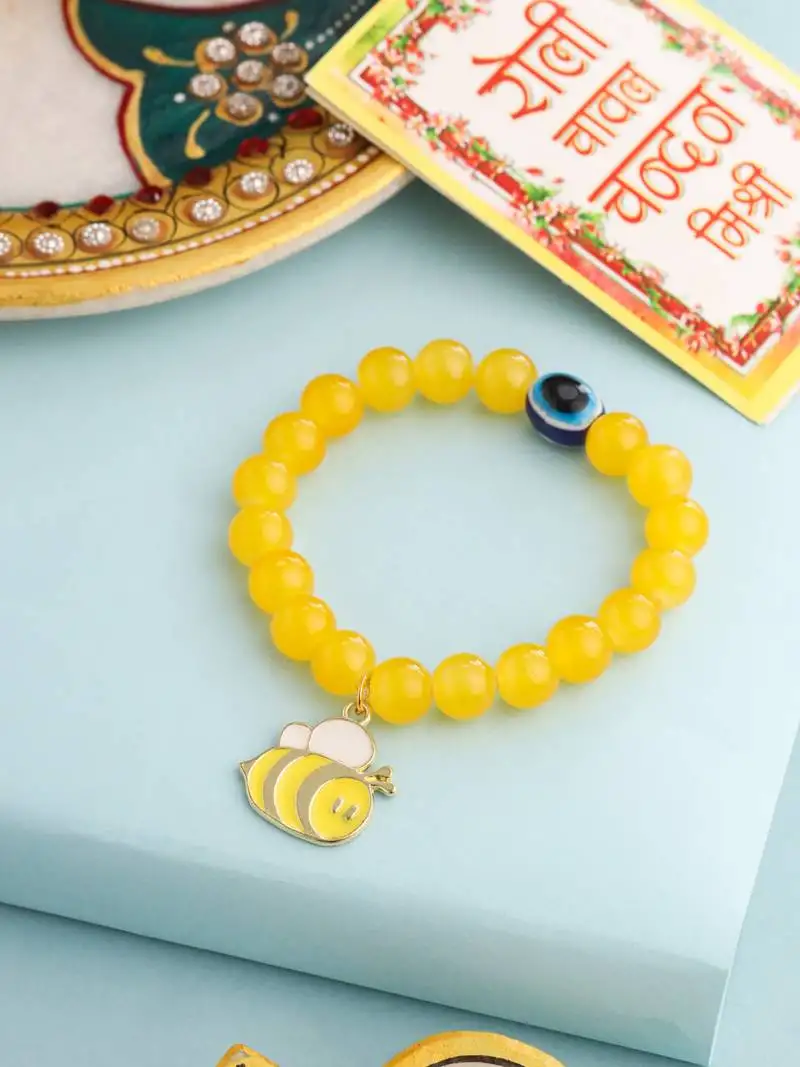 Kids cartoon design yellow artificial beads thread rakhi with roli chawal chandan & mishri