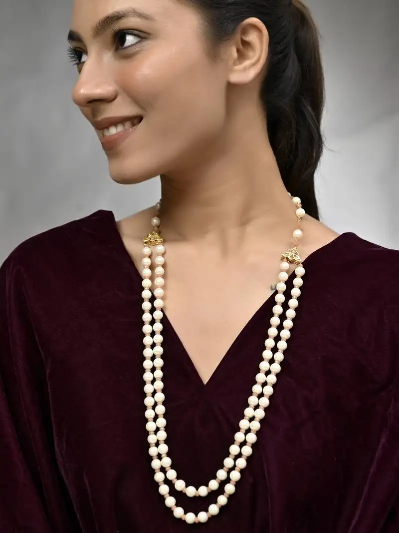 Double-strand pearl necklace with gold-toned clasps