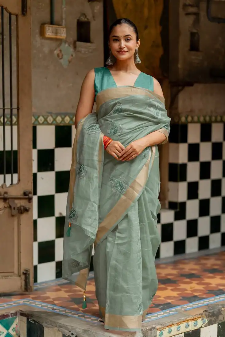 Sea green organza embroidered golden zari woven border saree with unstitched blouse piece