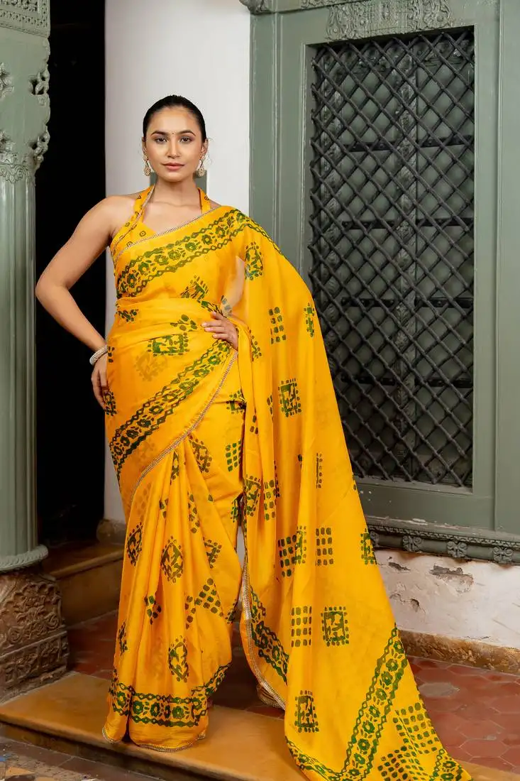 Dark yellow chiffon batik block print lace border saree with unstiched blouse piece