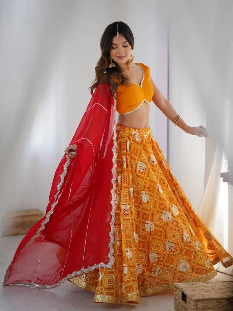 Yellow bandhani printed lehenga with blouse and red dupatta