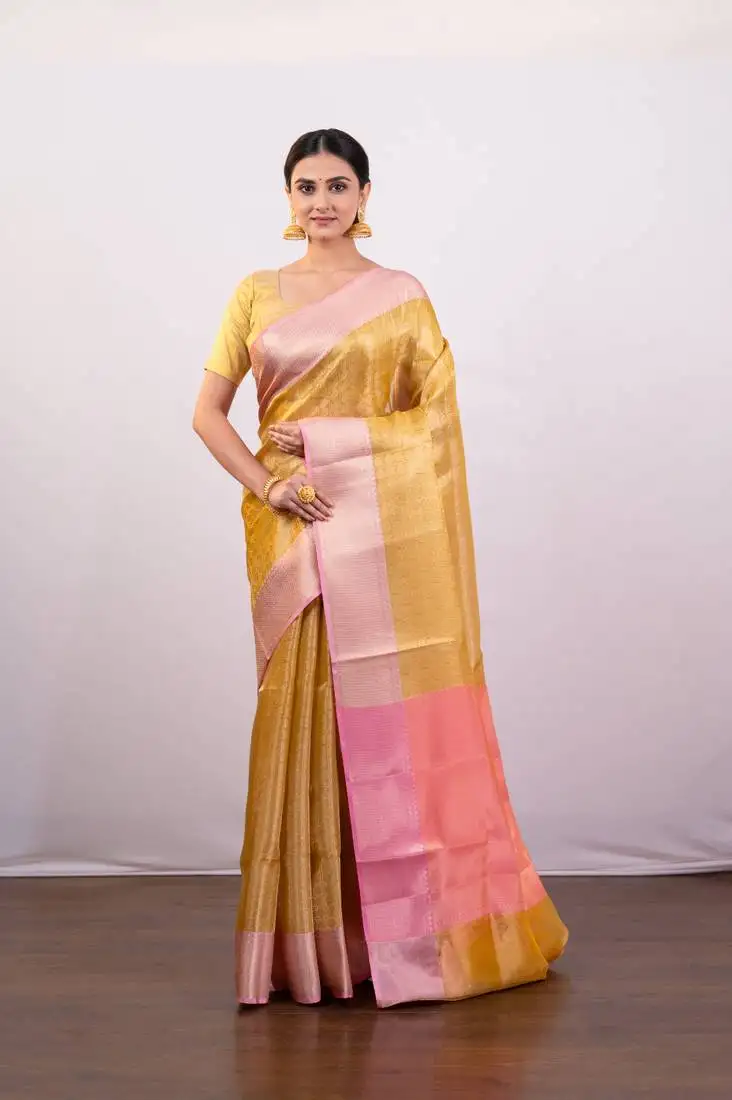 Gold tissue art silk saree with detailed pink zari border