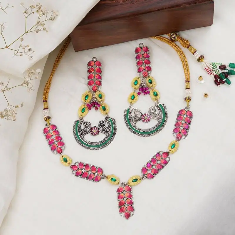 Bold red and green meenakari necklace with peacock motif earrings
