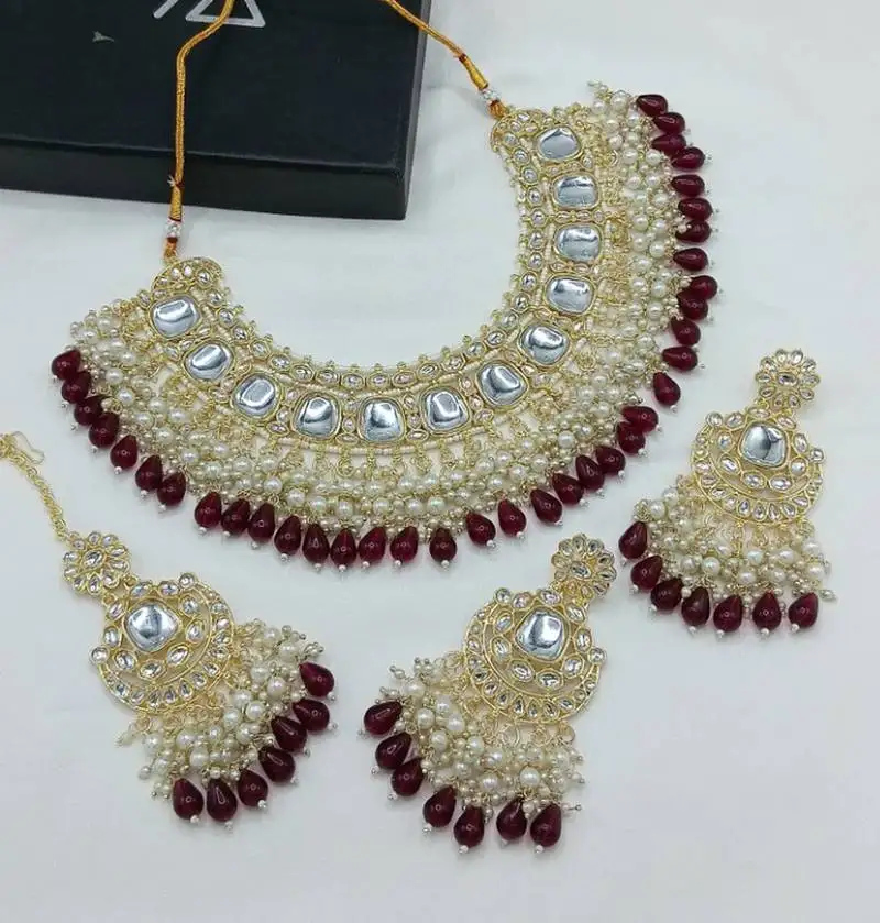 Luxurious kundan choker set with pearl and maroon bead accents - traditional indian bridal jewelry