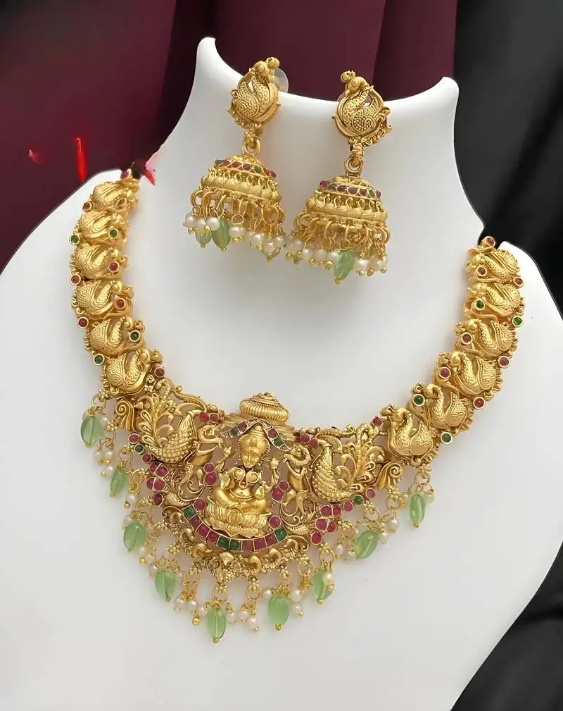 Opulent gold peacock lakshmi temple necklace set - handcrafted antique finish bridal jewelry with emerald & pearl accent