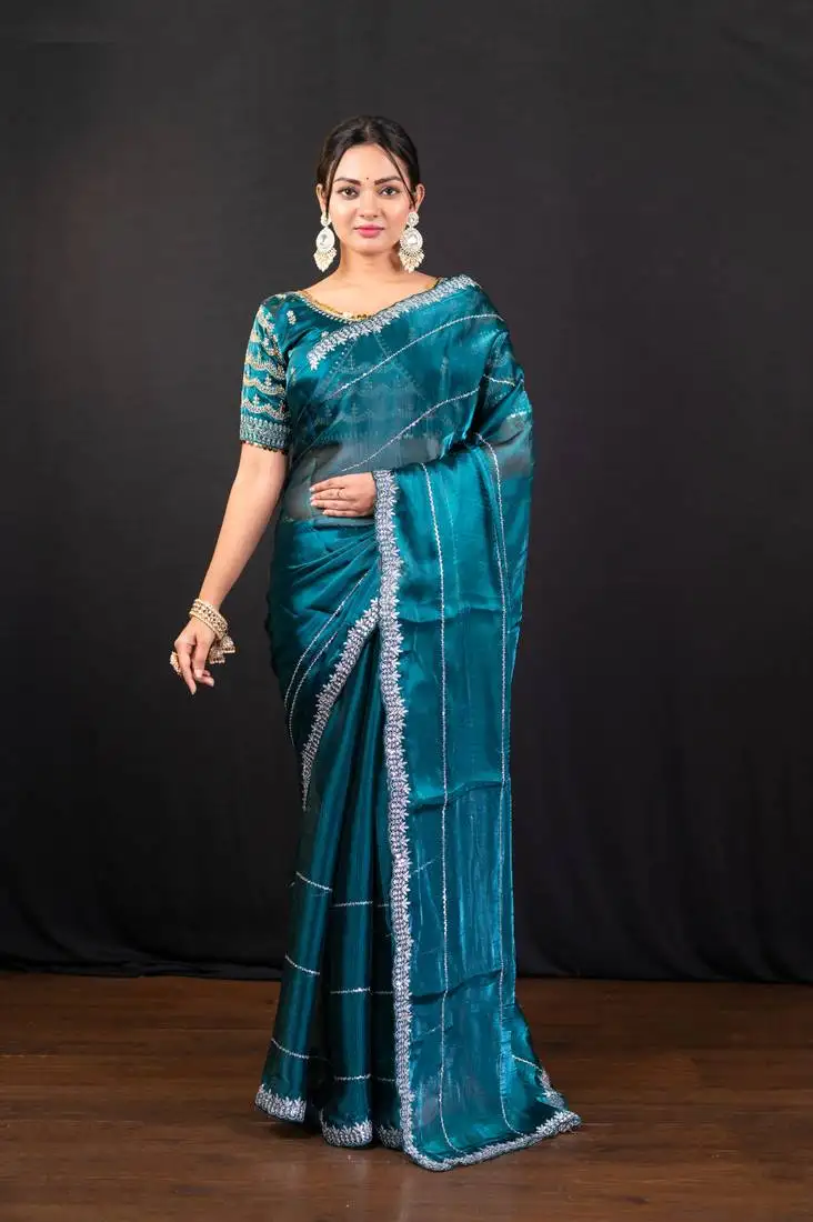 Teal blue jimmy choo saree with intricate silver embellishments and blouse