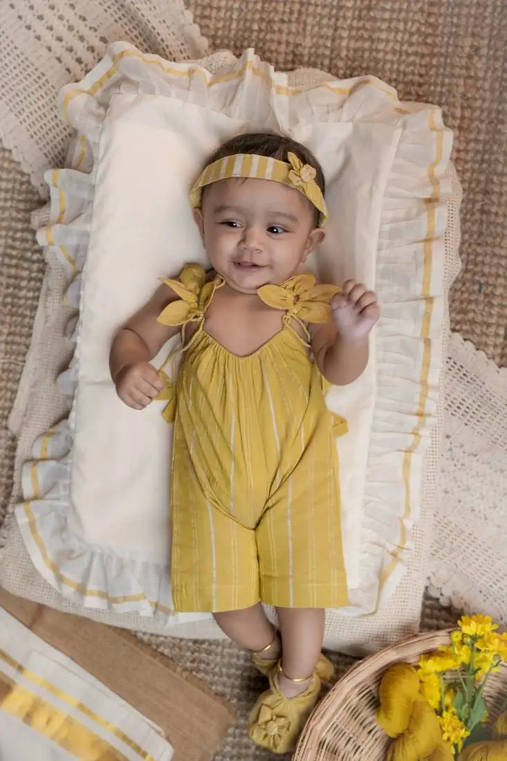 Yellow striped romper with fast kara adjustable straps.