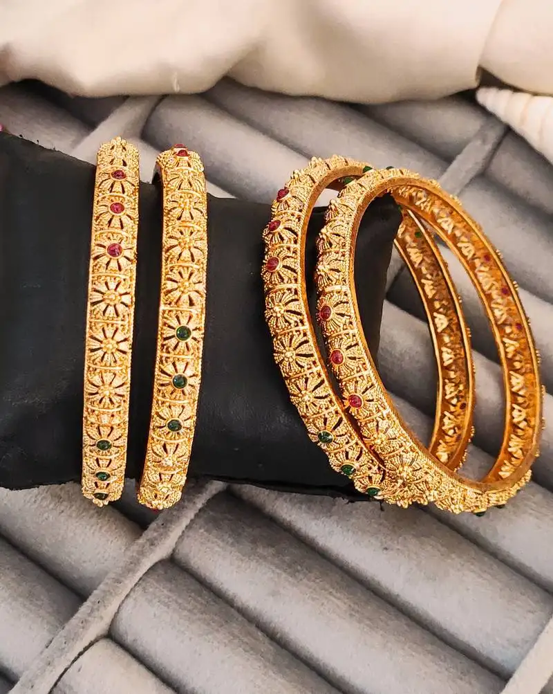 Gold-plated bangles set with floral design, red and green stones, set of 4
