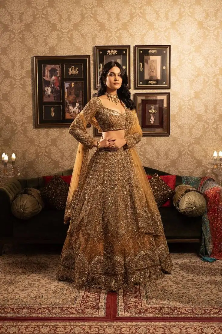 Gold net lehenga with heavy embellished rhinestones