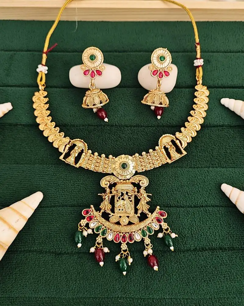 Temple jewellery rajwadi polish short necklace set with fancy design, red & green stones, and jhumka earrings.