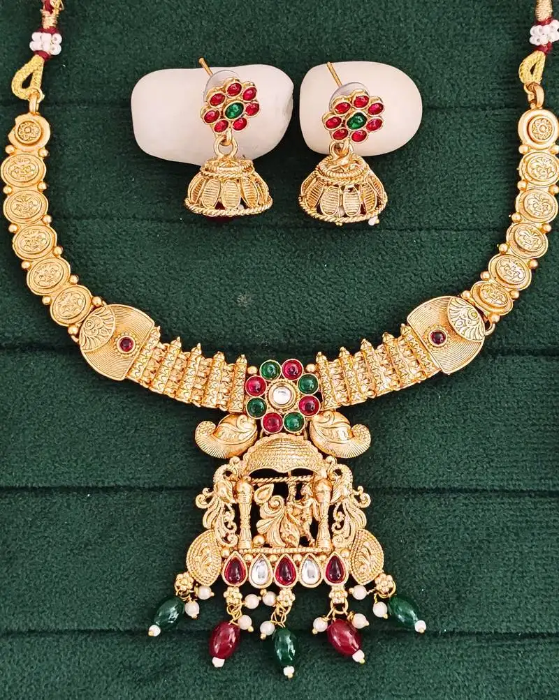 South indian jewelry necklace set with lakshmi pendant, ruby & green stones, coin design, and matching jhumka earrings