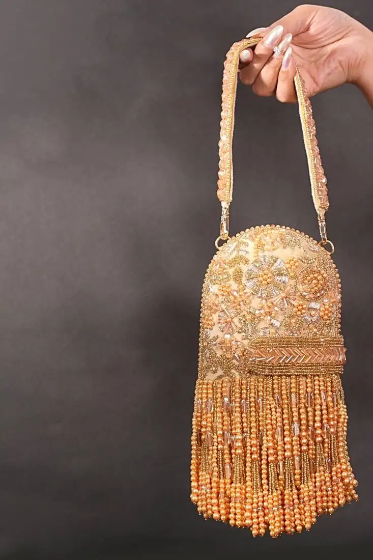 Azmat gold suede embellished capsule bag