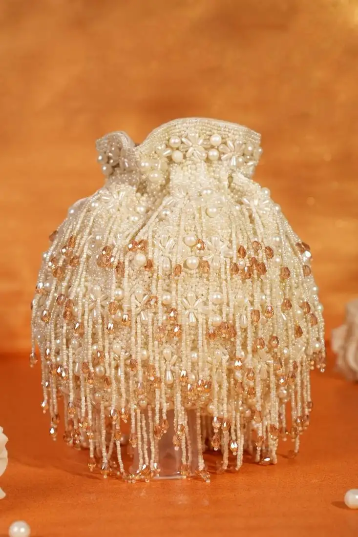 Nayera ivory suede pearl potli with crystals