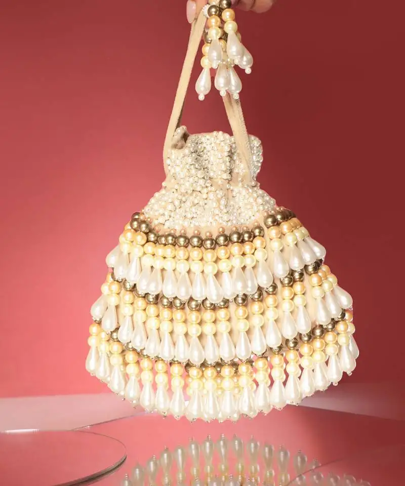 Beige semi suede pearl embroidered potli bag