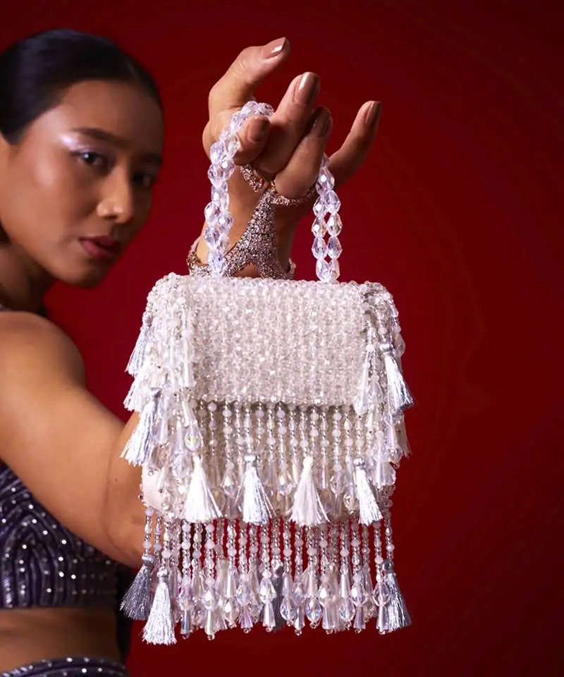 White suede embroidered handbag with flowy detailing