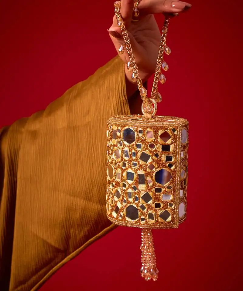Gold satin potli bag adorned with mirror detailing