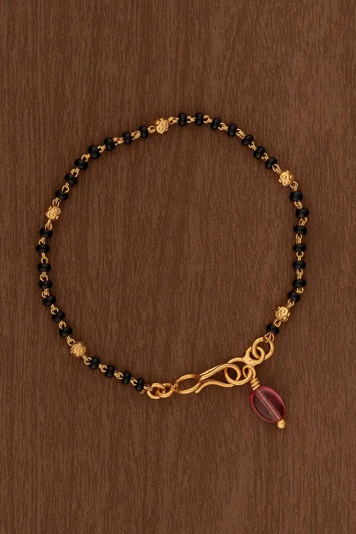 Black beads bracelet with ruby bead hanging one gram gold