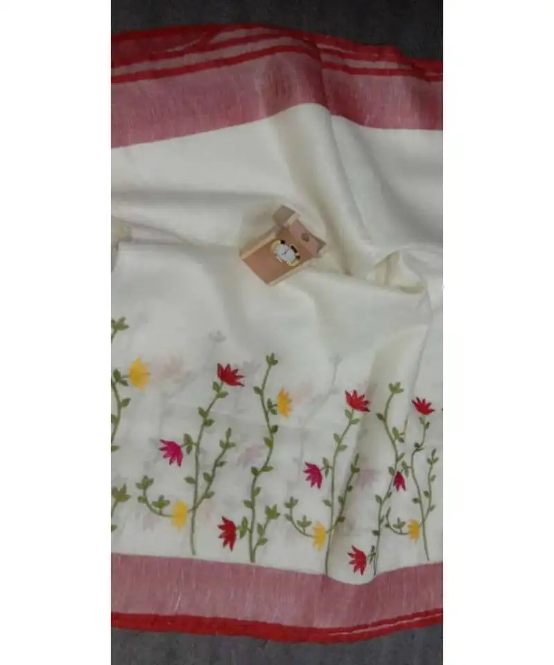 White handcrafted linen saree with embroidery work on the saree