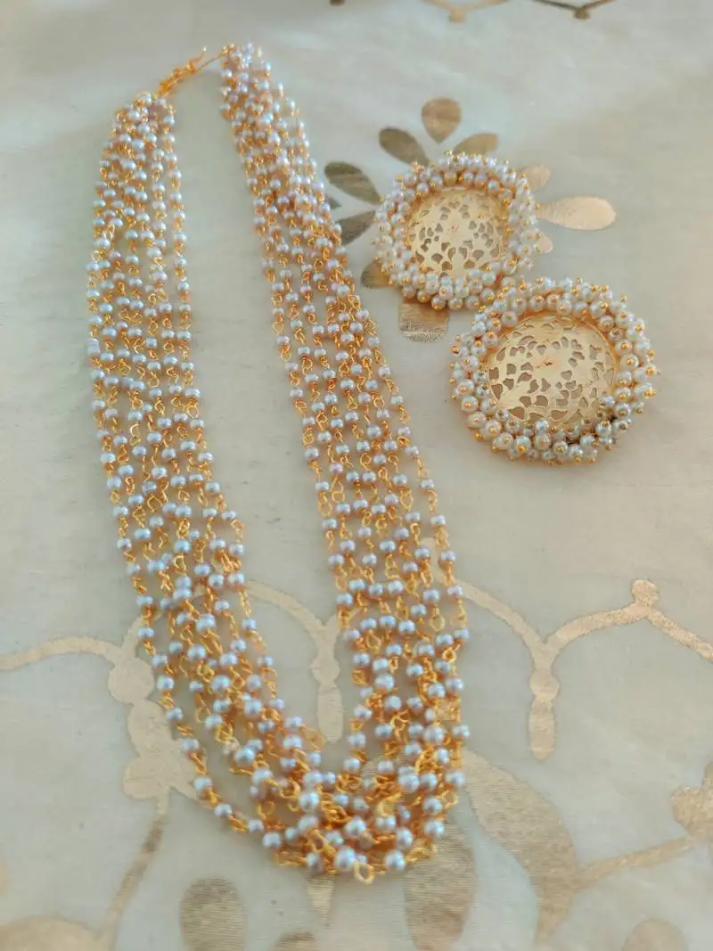 White pearl necklace set in matte gold polish