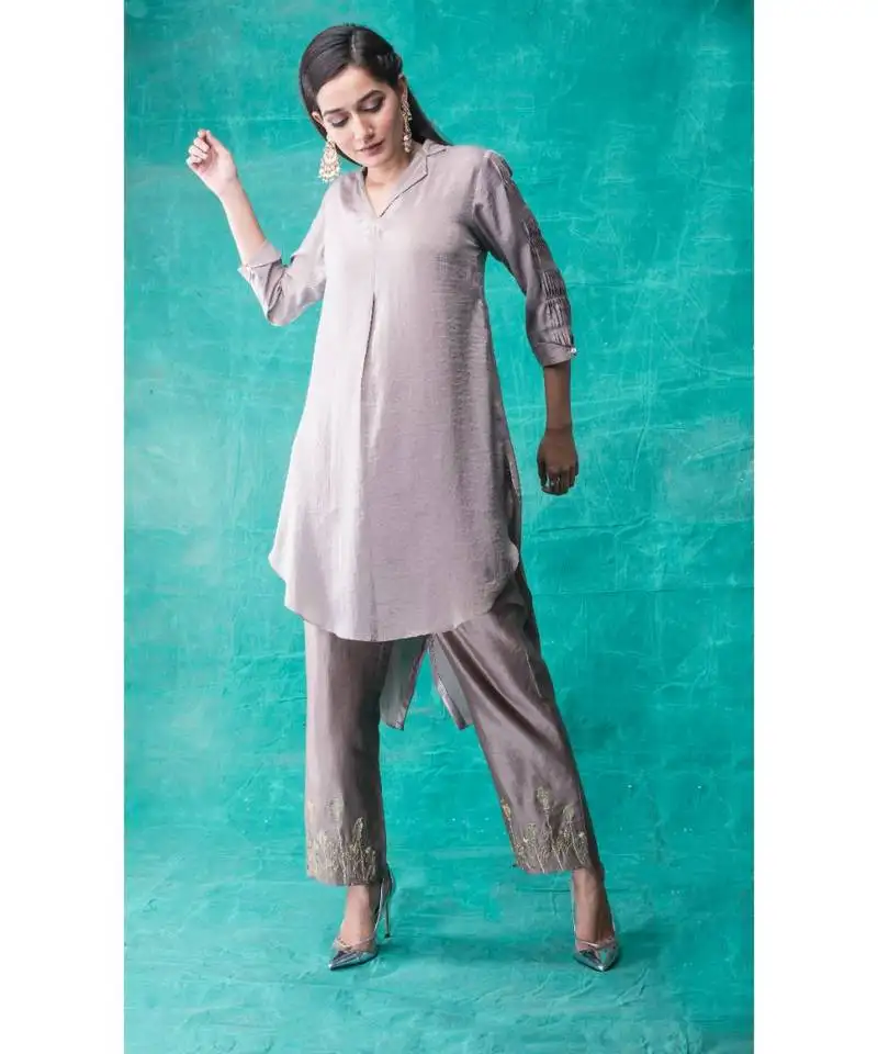 Show shaa high low fabric manipulated kurta waccompanied byembroided golden birds on pants.