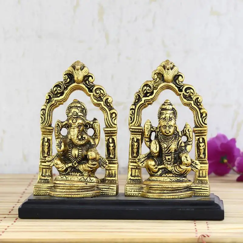 Golden metal statue of goddess laxmi and lord ganesha