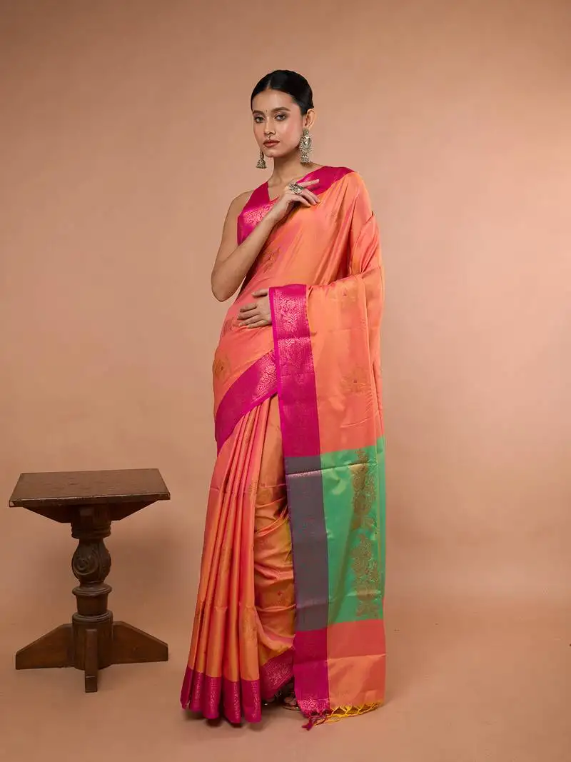 Orange blended silk saree with broad pink border