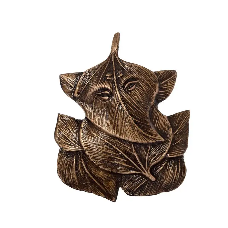 Brass antique finish ganesha design on leaves wall hanging