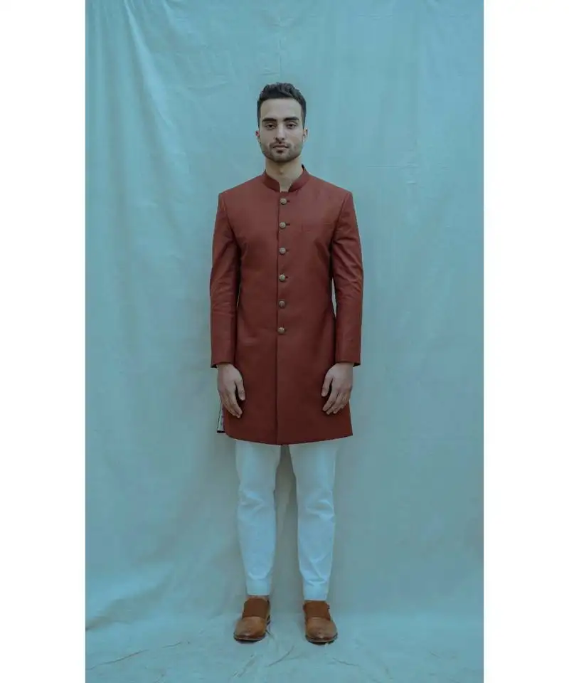 Rust color achkan with white kurta and white pants