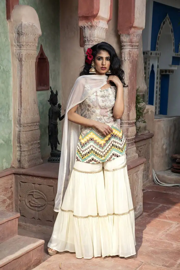 Cream printed sleveless kurta with sharara and dupatta