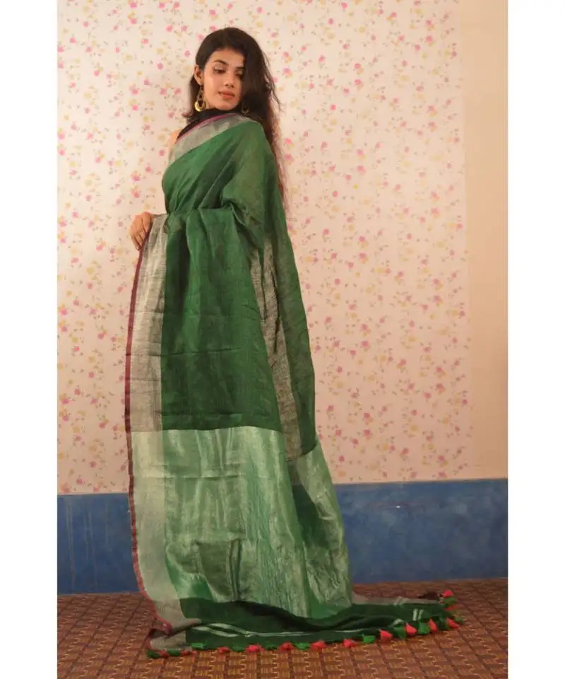 Bottle green linen saree with blouse with zari border