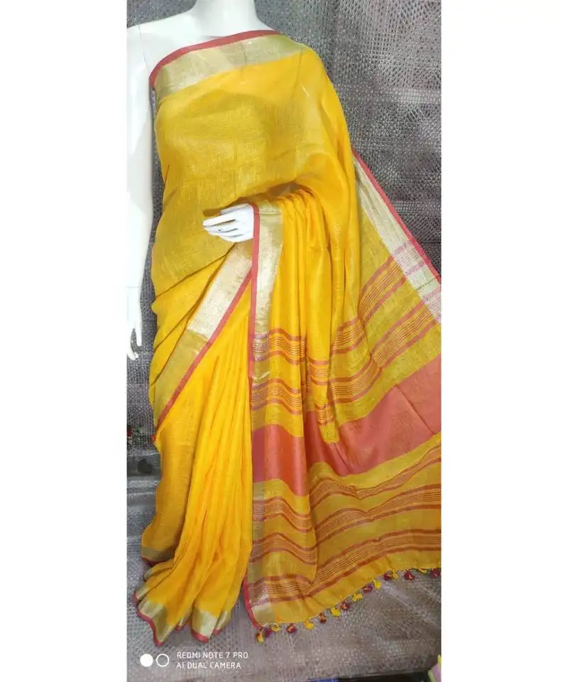 Yellow shade linen saree with blouse with zari border