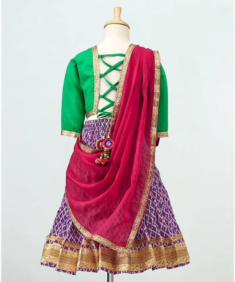 Purple printed lehenga with contrast green tie back choli and pink dupatta