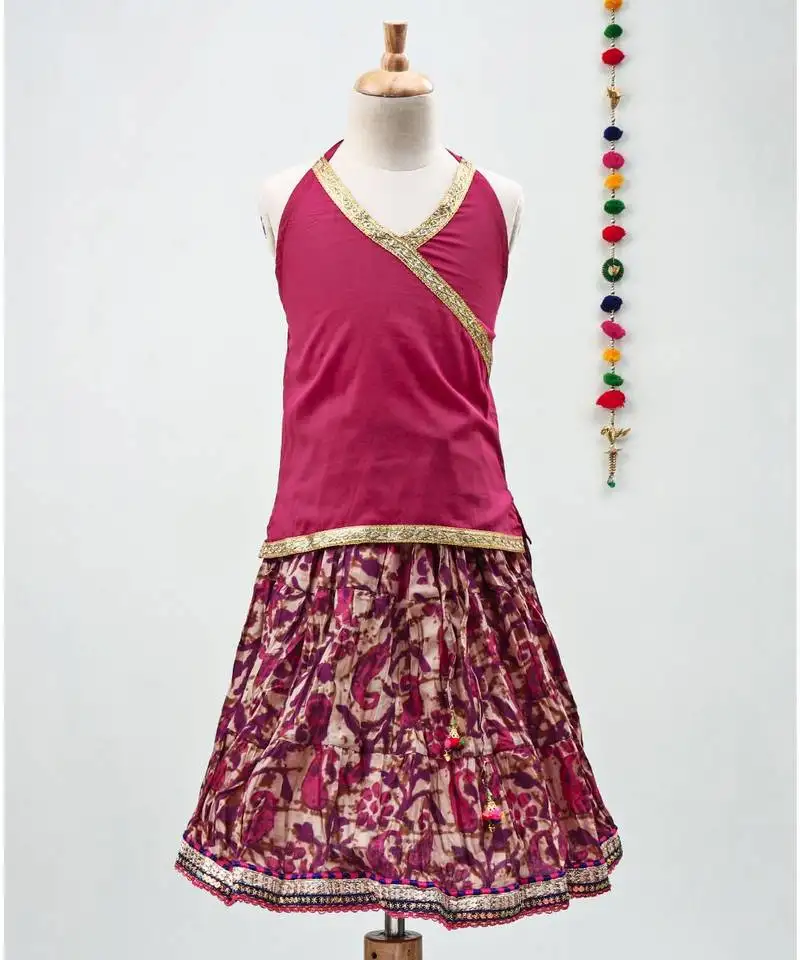 Pink cotton paisley printed lehenga with a halter neck choli and golden lace